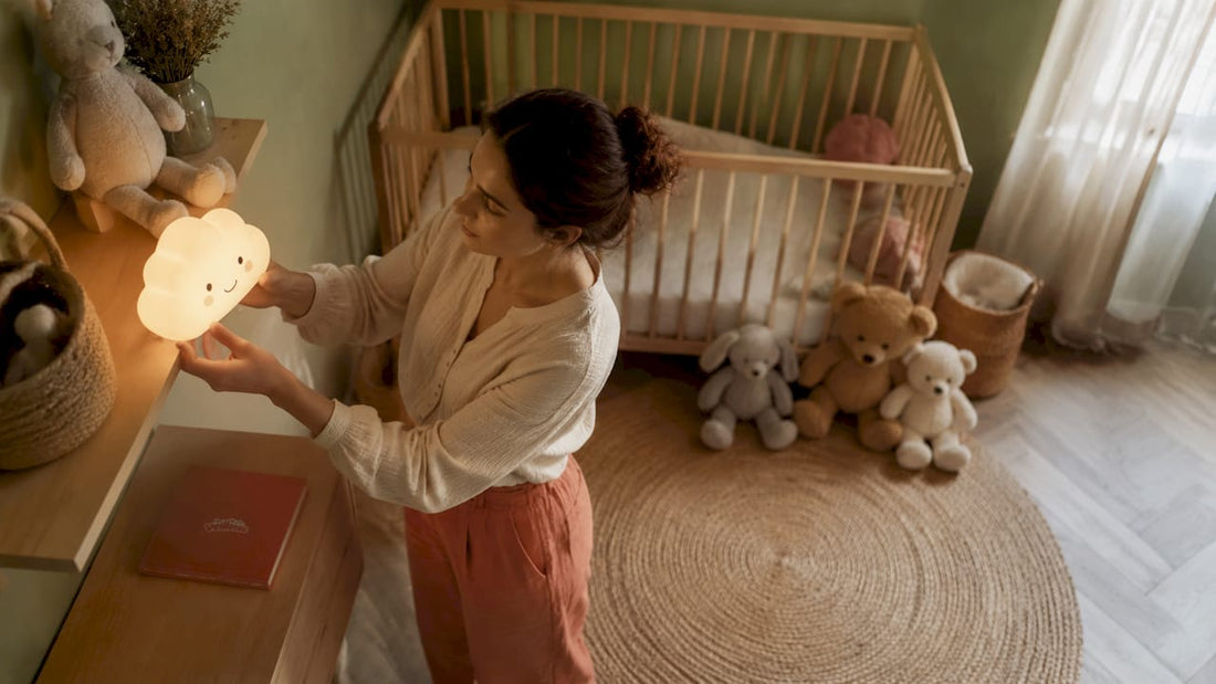 Une maman installe une veilleuse sur l’étagère de la chambre de bébé.